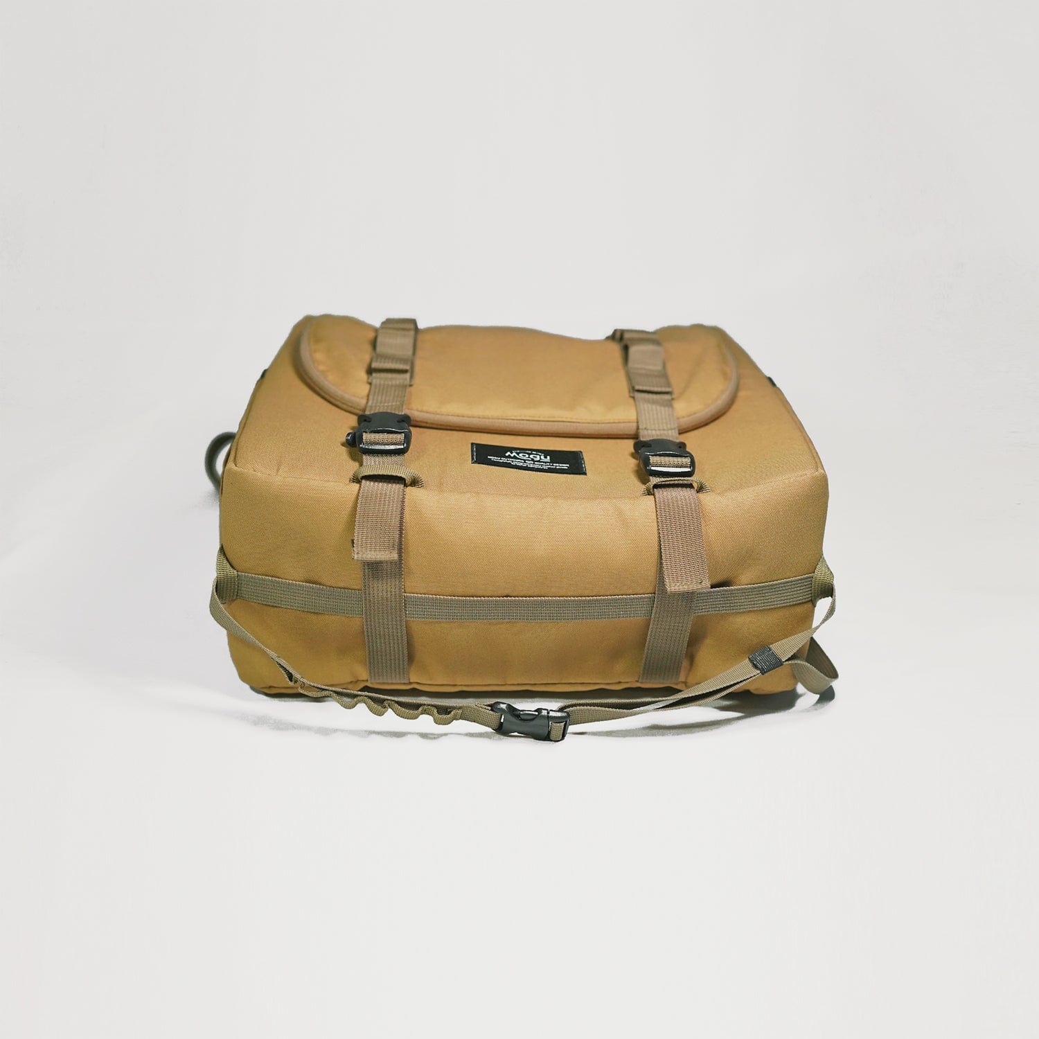 View of kitchen caddy bag lying down, with a strap for paper towel to hang from and straps to hook other items like torches and carabiners etc.